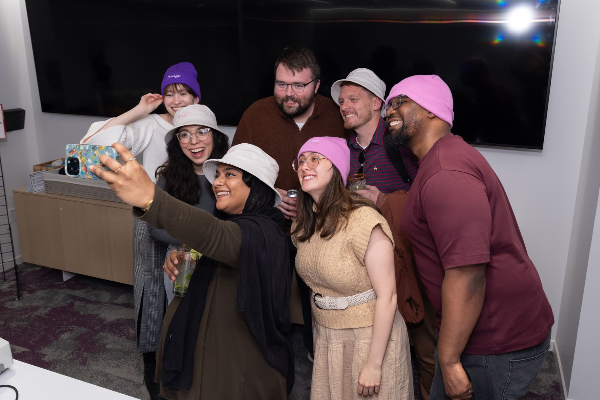 a group of people are taking a selfie together in a room